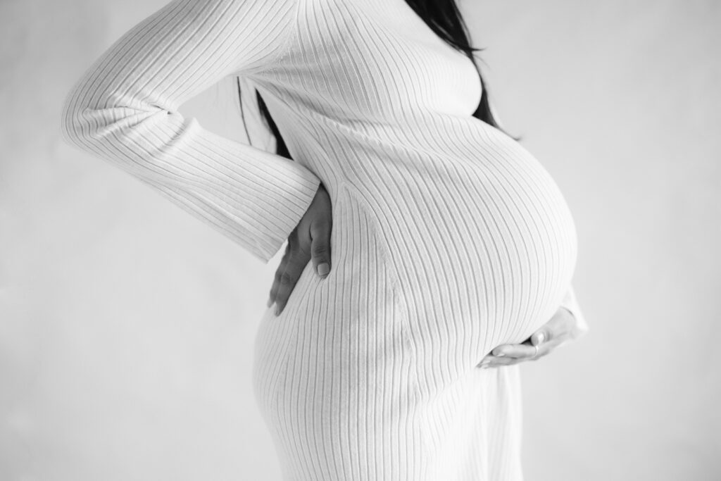 photo of pregnant woman wearing form fitting dress
