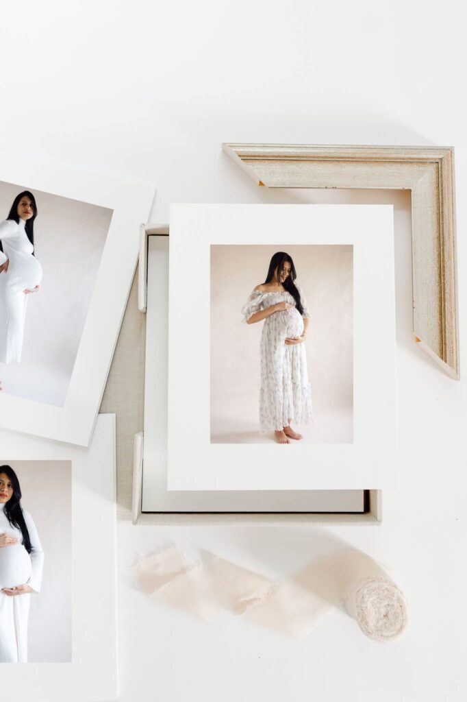 A collection of heirloom maternity portraits printed and matted inside a fine art folio box, created by Fort Collins newborn and motherhood photographer.