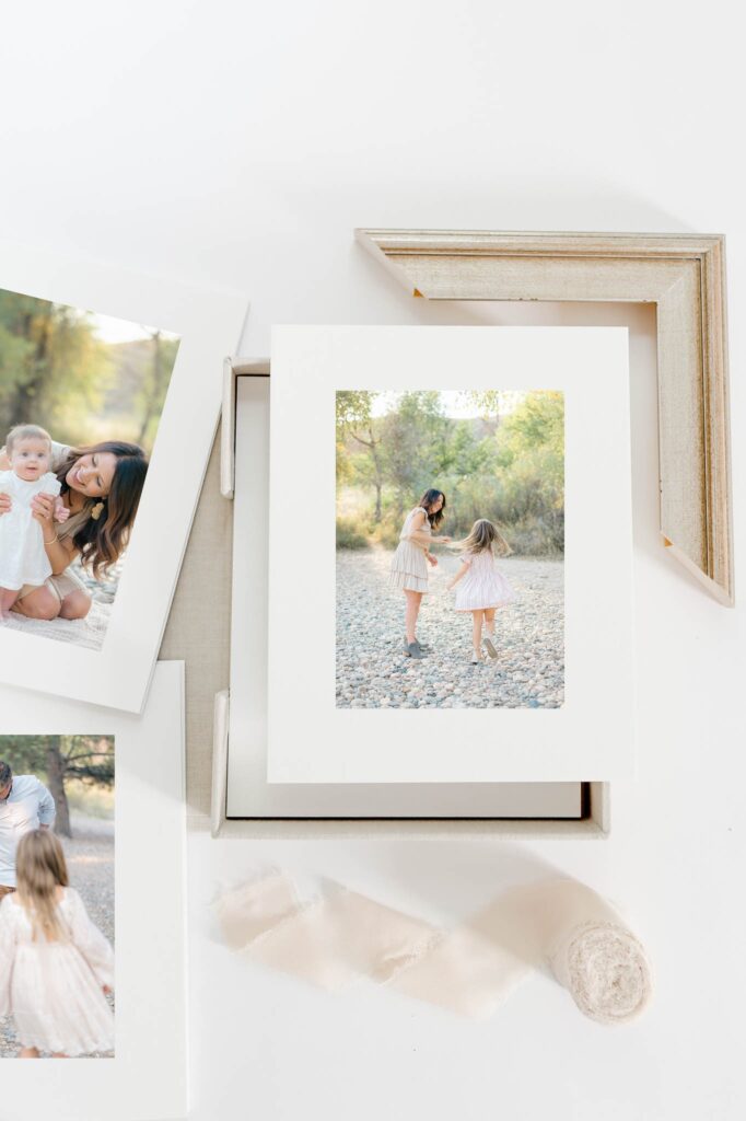 A timeless mother and daughter portrait print displayed in a folio box with framing samples, created by a northern Colorado motherhood photographer.