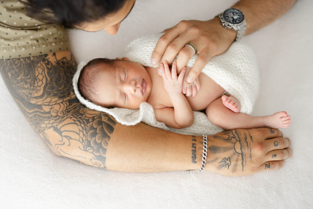 Dad cradling newborn baby