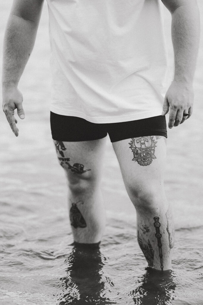photo of mans legs standing in lake