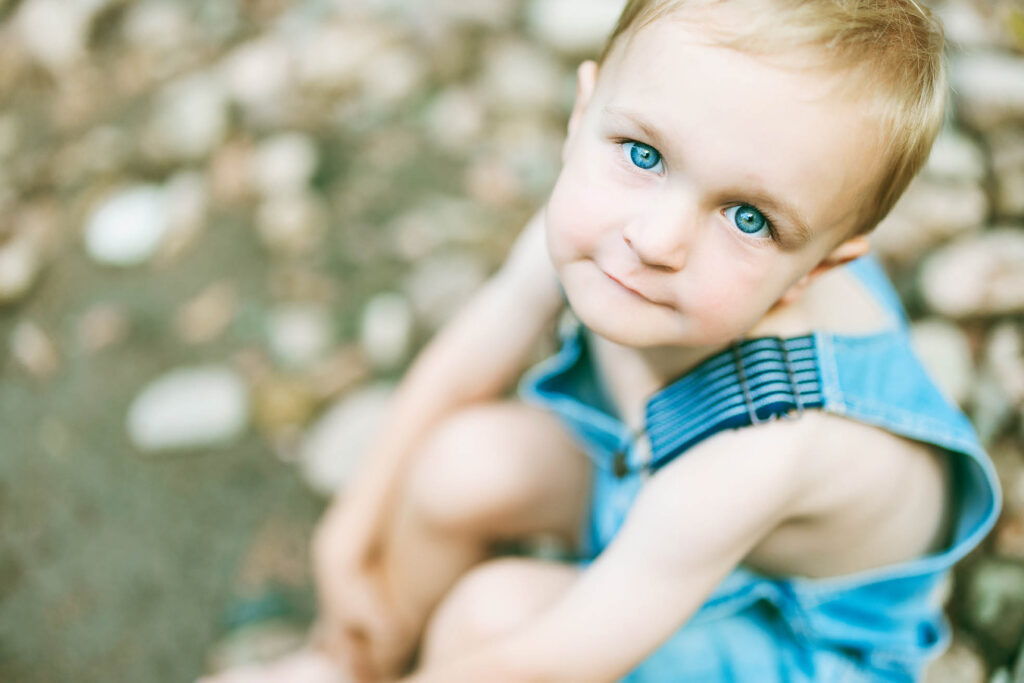 boy with big blue eyes looking up at camera