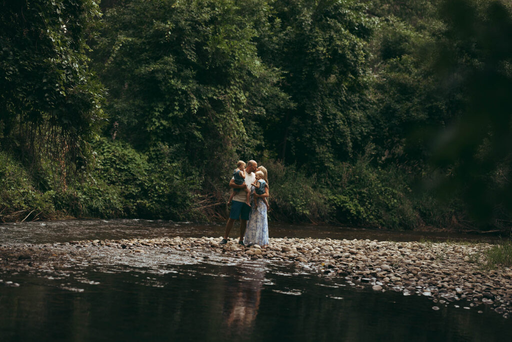 cinematic photo of a family near river on a late summer evening