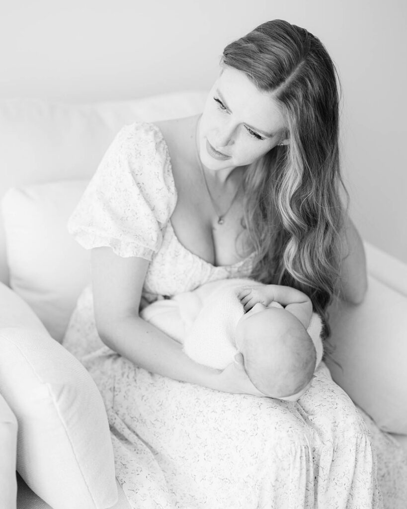 mother holding newborn baby in lap