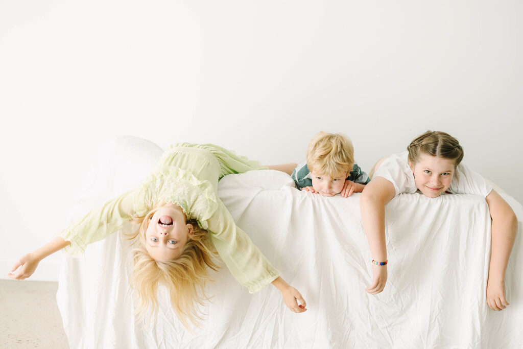 3 kids playing on a couch