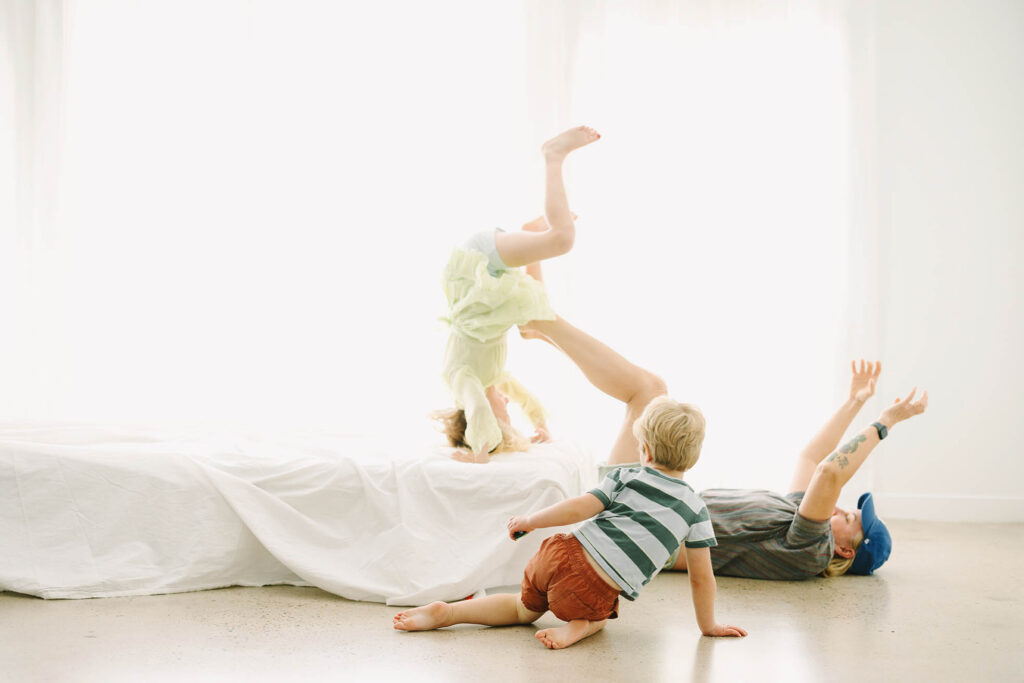 grandma plating with and tossing granddaughter onto a bed