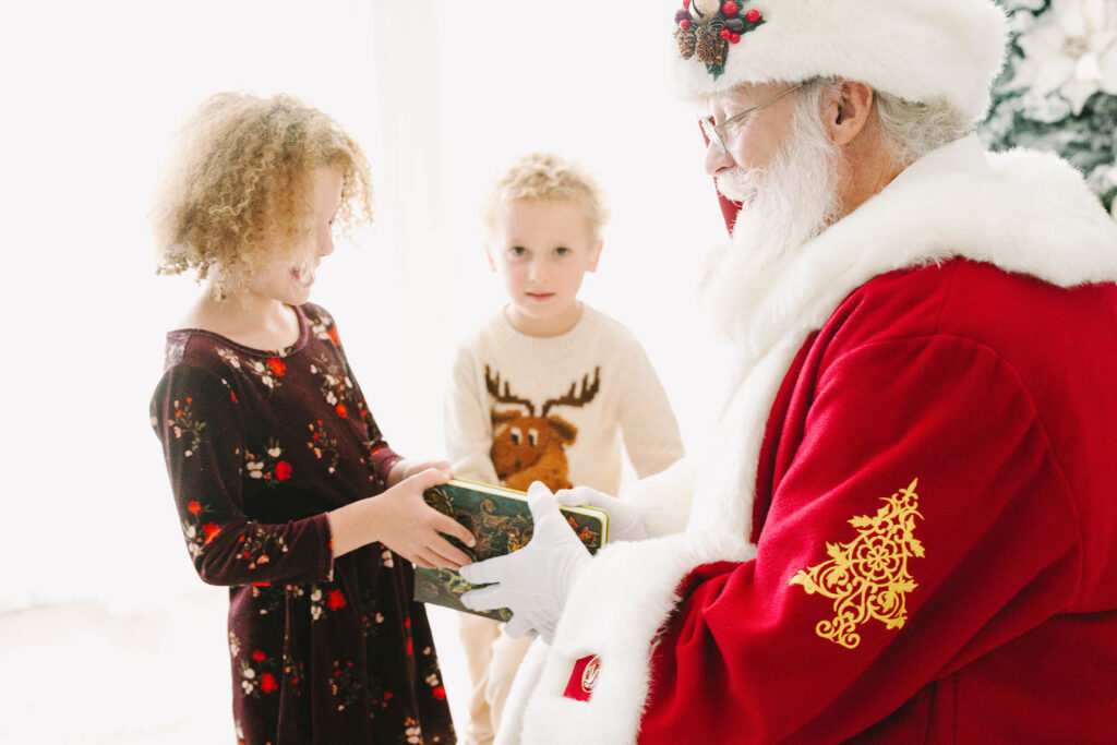 Santa showing a little girl his "Nice list"