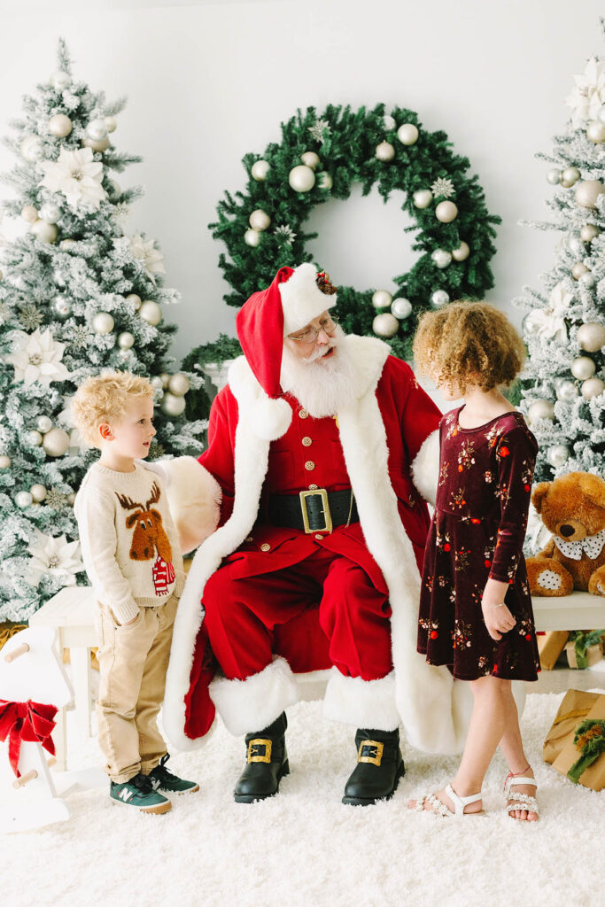 Santa chatting with a brother and sister
