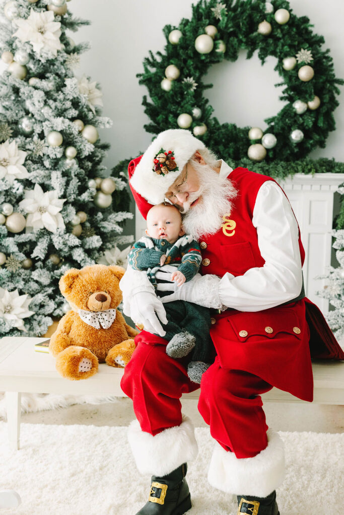 Santa lovingly hugging a baby