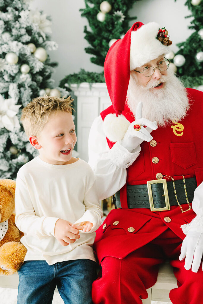 Santa telling a joke and a yound boy laughing