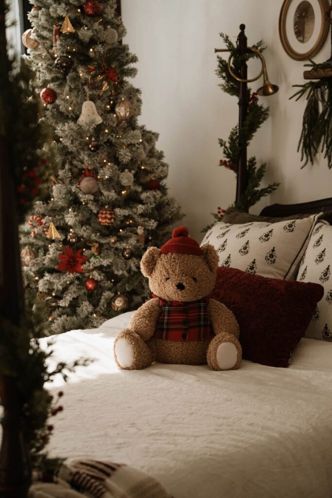 close up shot of a teddy bear in a cozy bedroom Christmas set for Christmas mini session photos in Denver studio